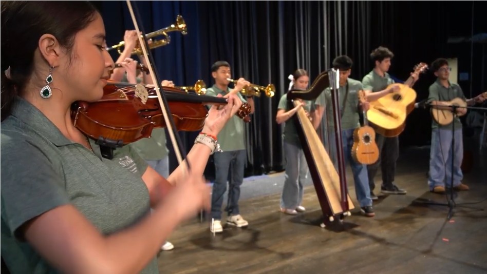 Students performing in Albuquerque Mariachi band on stage